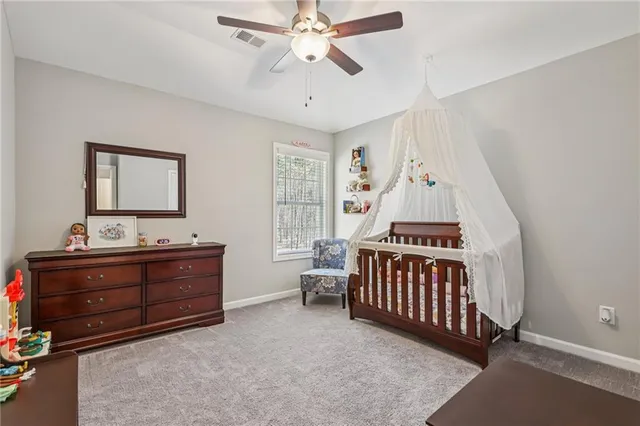 a living room with furniture and a baby crib