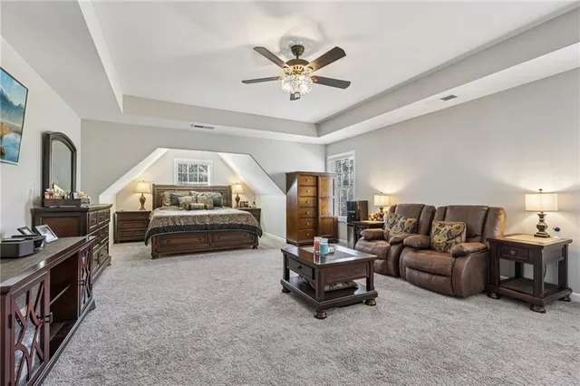 a living room with furniture and a ceiling fan