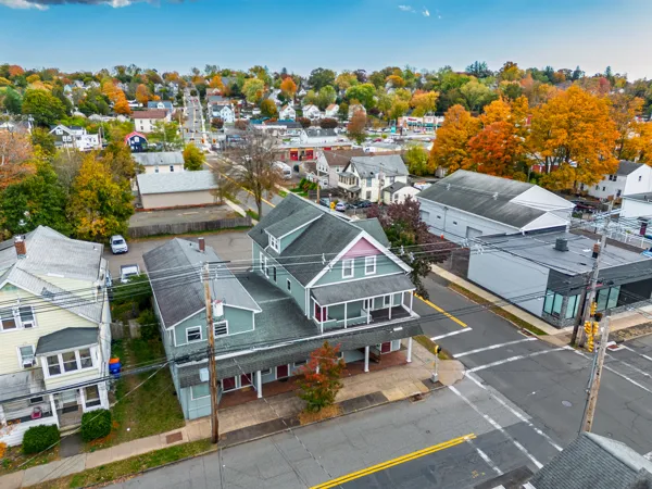 an aerial view of a residential houses with city view