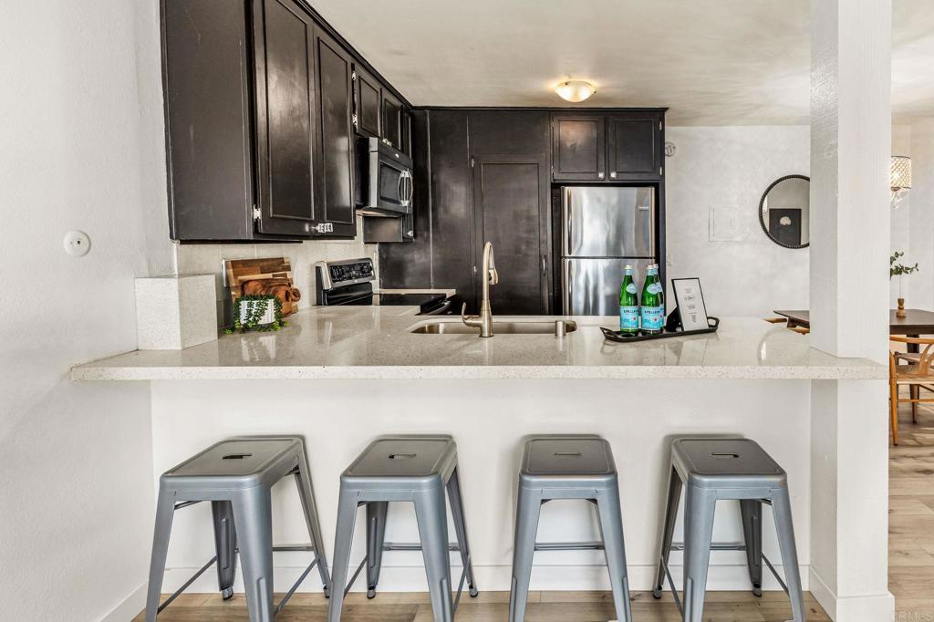 6780 Friars Road, Unit 129 San Diego, CA 92108 - Photo 12 of 50 a kitchen with cabinets and chairs