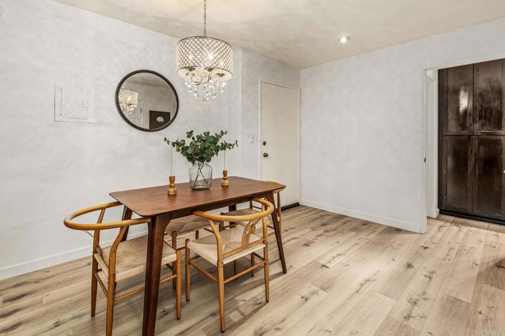 6780 Friars Road, Unit 129 San Diego, CA 92108 - Photo 13 of 50 a dining room with wooden floor a glass table and chairs