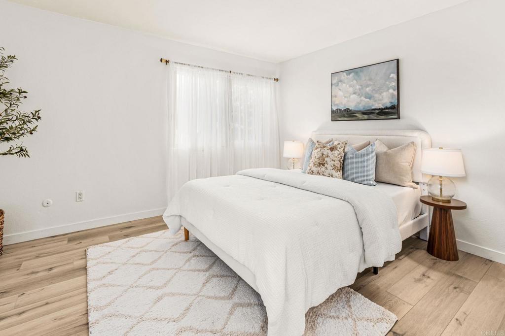 6780 Friars Road, Unit 129 San Diego, CA 92108 - Photo 16 of 50 a bedroom with a bed and a painting on the wall