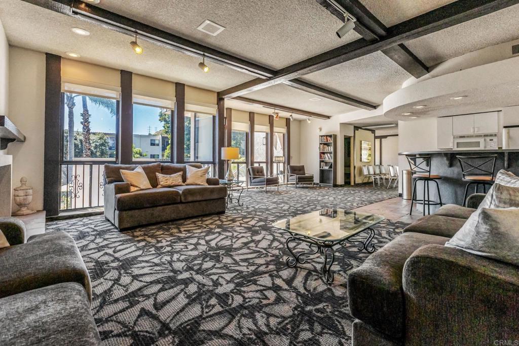 6780 Friars Road, Unit 129 San Diego, CA 92108 - Photo 40 of 50 a living room with furniture and a floor to ceiling window