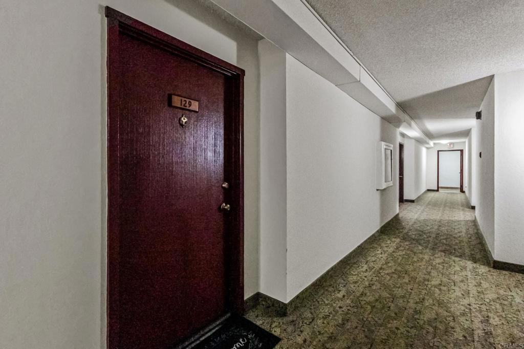 6780 Friars Road, Unit 129 San Diego, CA 92108 - Photo 48 of 50 a view of a hallway with wooden floor