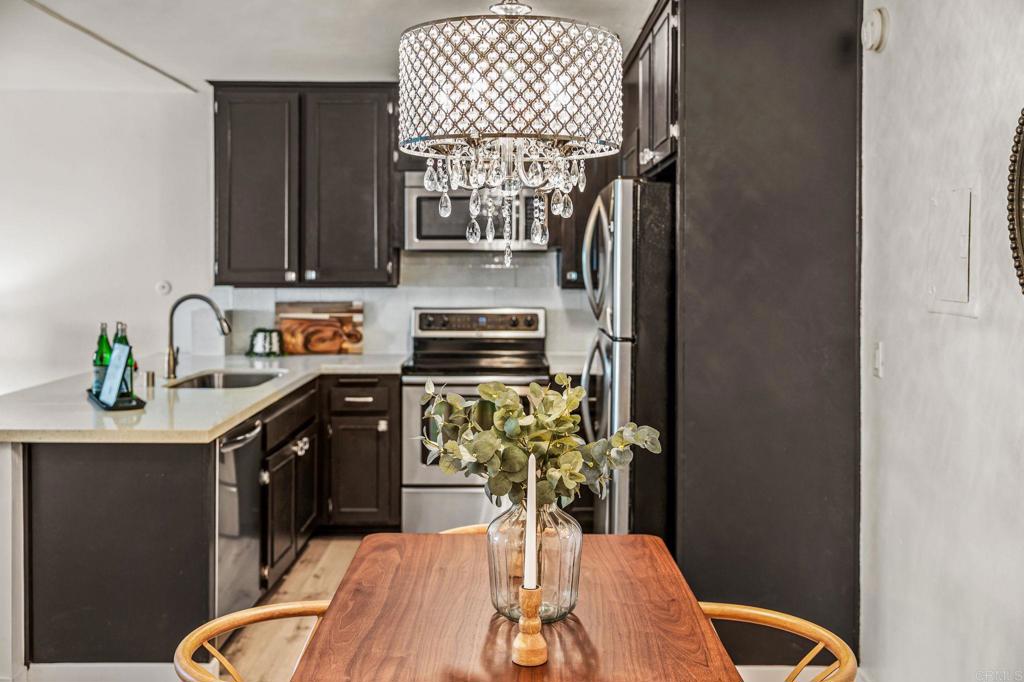 6780 Friars Road, Unit 129 San Diego, CA 92108 - Photo 7 of 50 a kitchen with stainless steel appliances a sink stove and cabinets