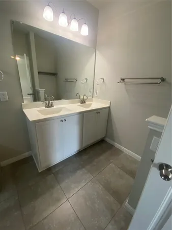a bathroom with a shower sink and mirror