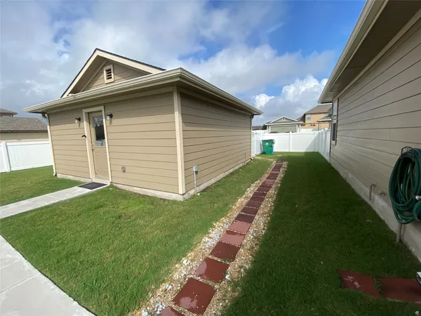 a backyard of a house with dishwasher and garden