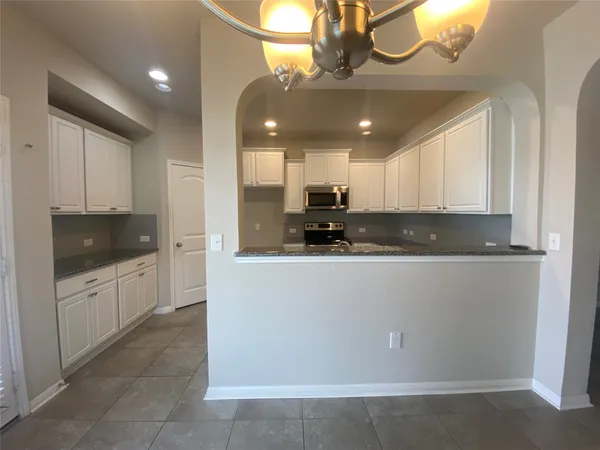 a kitchen with a sink stainless steel appliances and cabinets