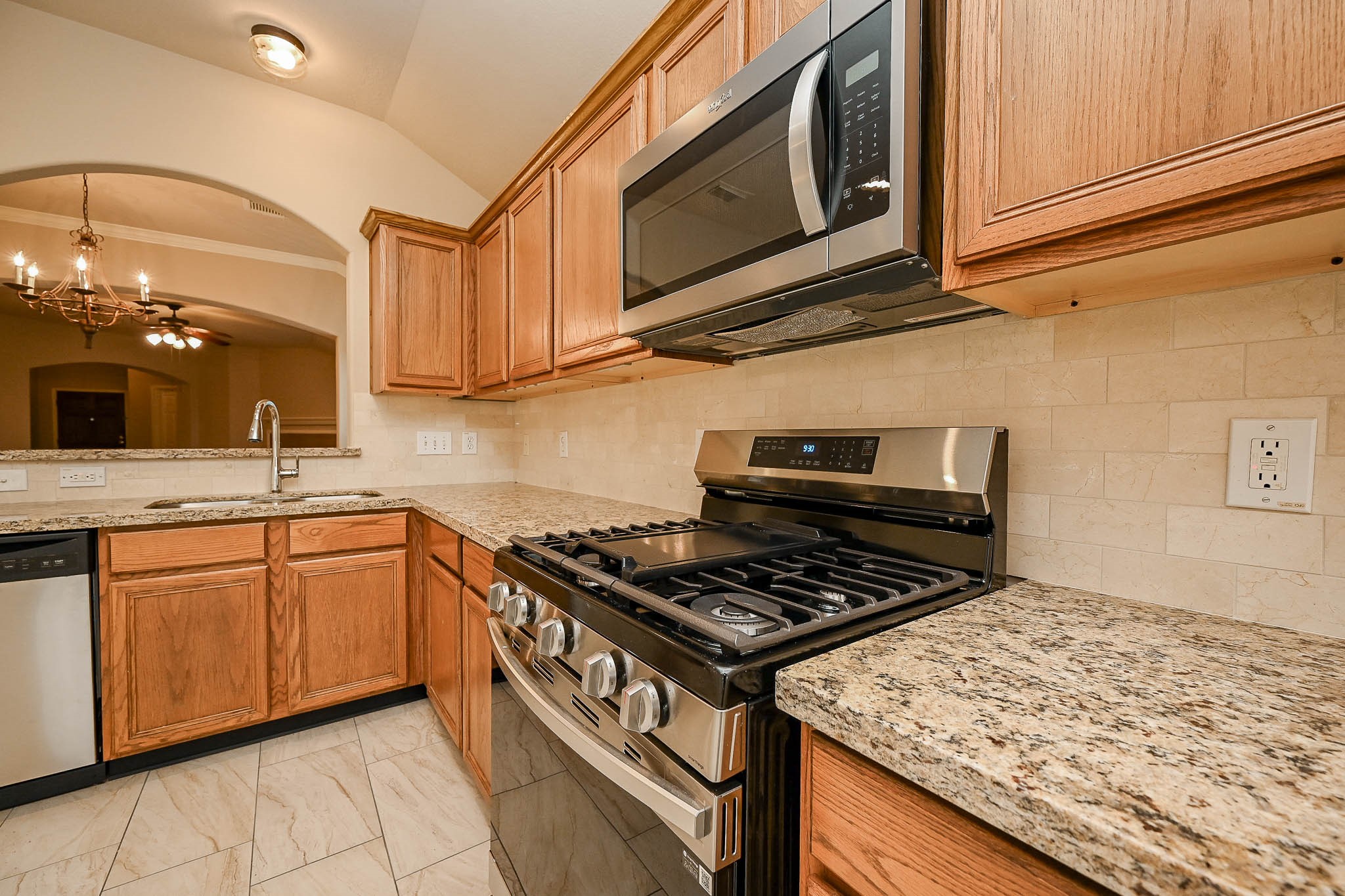 18518 Shadow Line Court Katy, TX 77449 - Photo 14 of 32 a kitchen with stainless steel appliances granite countertop a stove and a sink
