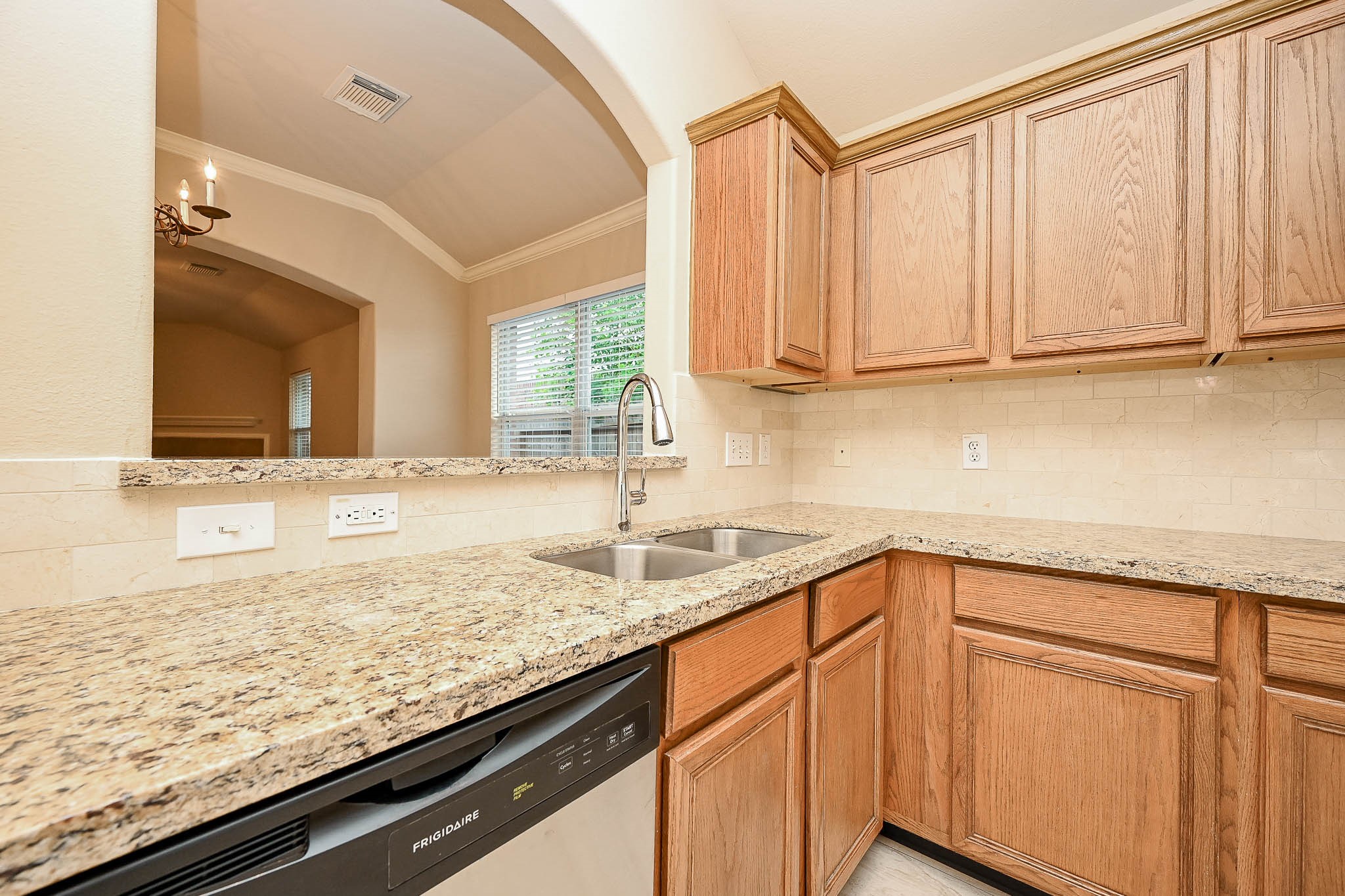 18518 Shadow Line Court Katy, TX 77449 - Photo 15 of 32 a kitchen with granite countertop sink cabinets and a wooden floor