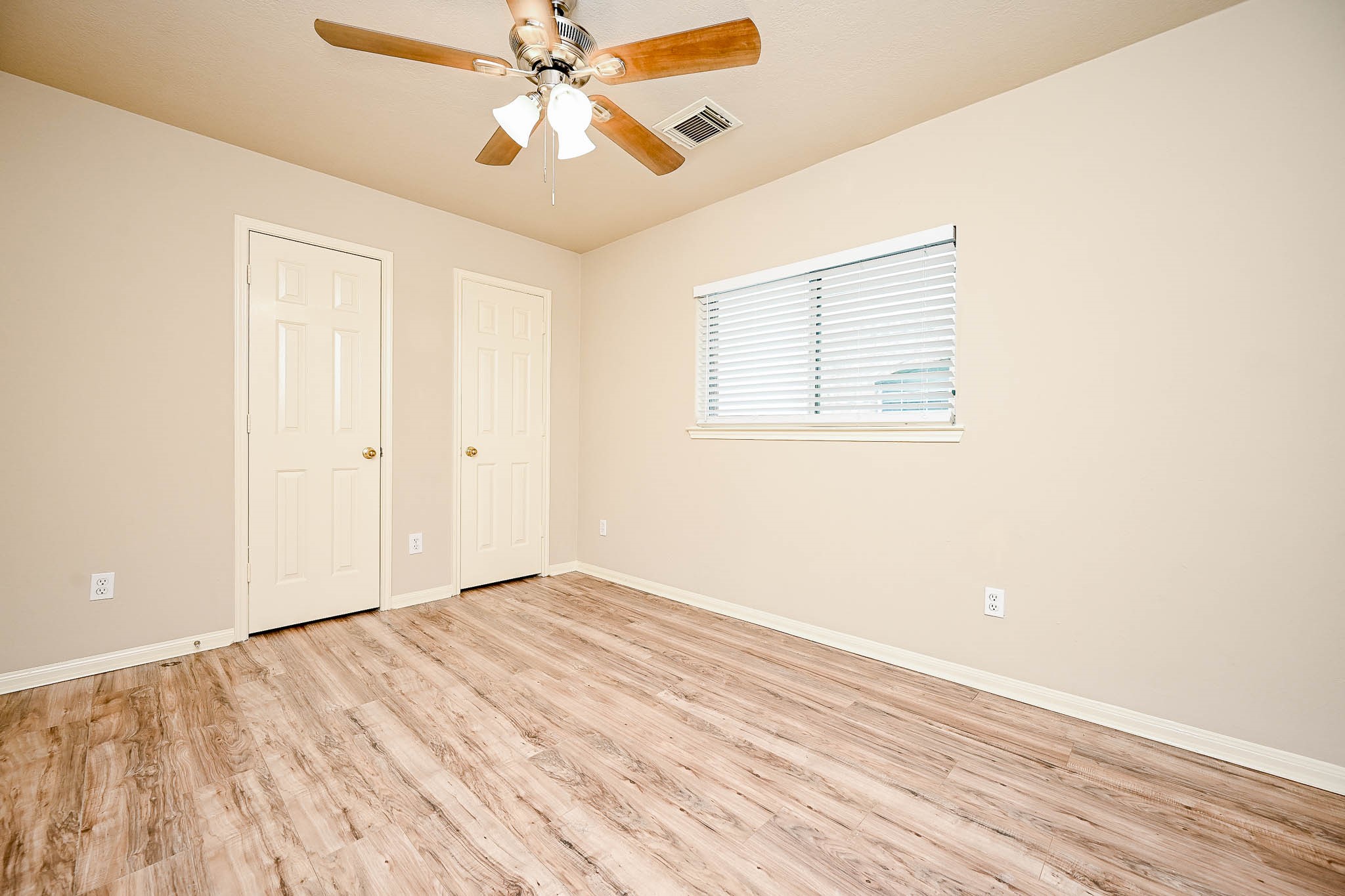 18518 Shadow Line Court Katy, TX 77449 - Photo 28 of 32 an empty room with wooden floor fan and windows