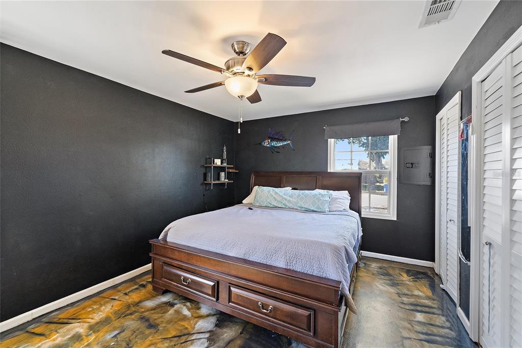 1056 Hope Street Venice, FL 34285 - Photo 16 of 27 a bedroom with a bed and a chandelier