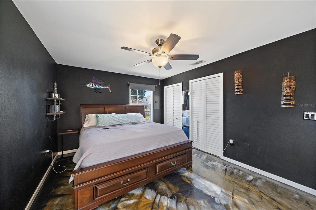 1056 Hope Street Venice, FL 34285 - Photo 18 of 27 a bedroom with a bed and a chandelier