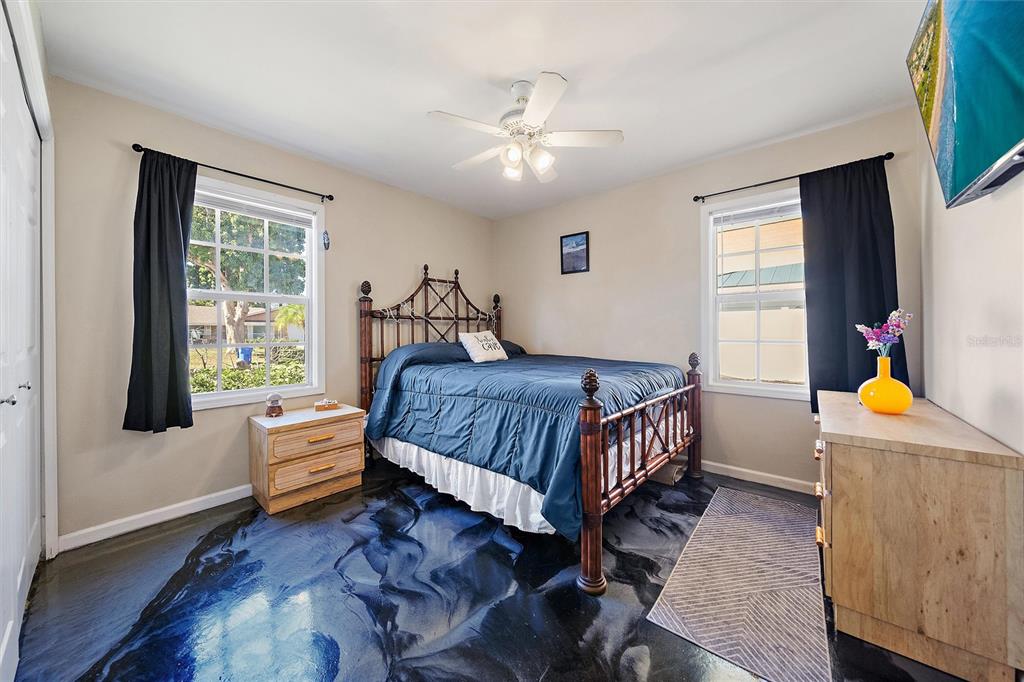 1056 Hope Street Venice, FL 34285 - Photo 19 of 27 a bedroom with a bed and wooden floor