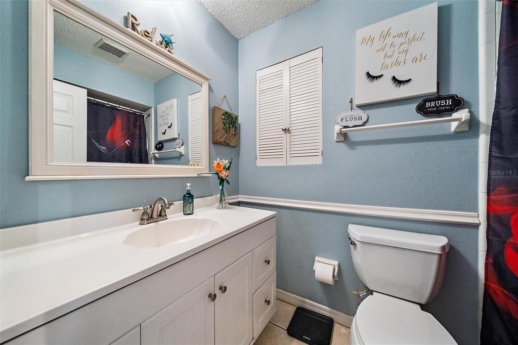 1056 Hope Street Venice, FL 34285 - Photo 20 of 27 a bathroom with a toilet a sink and mirror