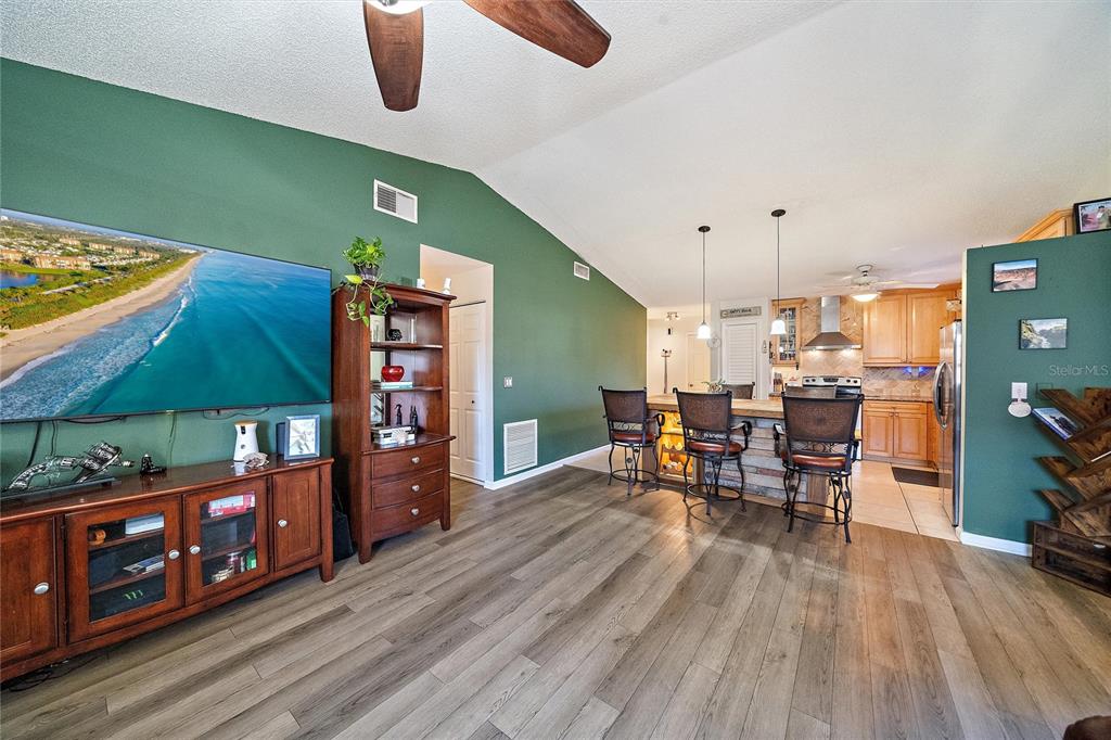 1056 Hope Street Venice, FL 34285 - Photo 3 of 27 a dining room with furniture and wooden floor