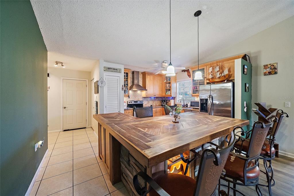 1056 Hope Street Venice, FL 34285 - Photo 4 of 27 a view of a dining table chairs and chandelier