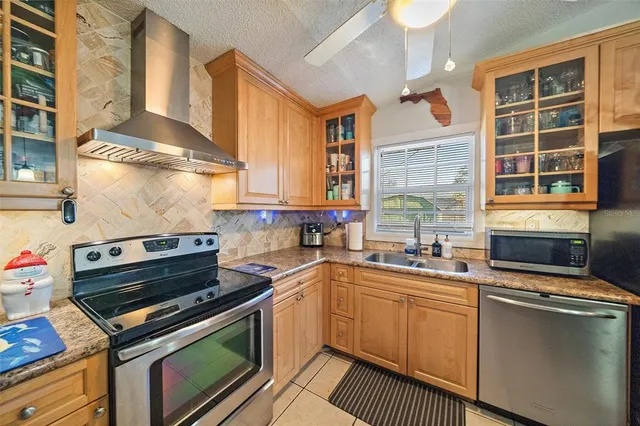 a kitchen with a stove a sink and a microwave