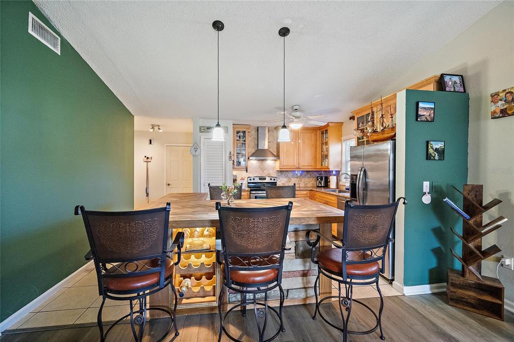 1056 Hope Street Venice, FL 34285 - Photo 9 of 27 a view of a dining room with furniture window and wooden floor