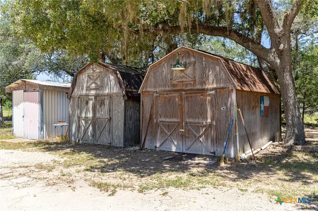 a view of a backyard with a garden and trees