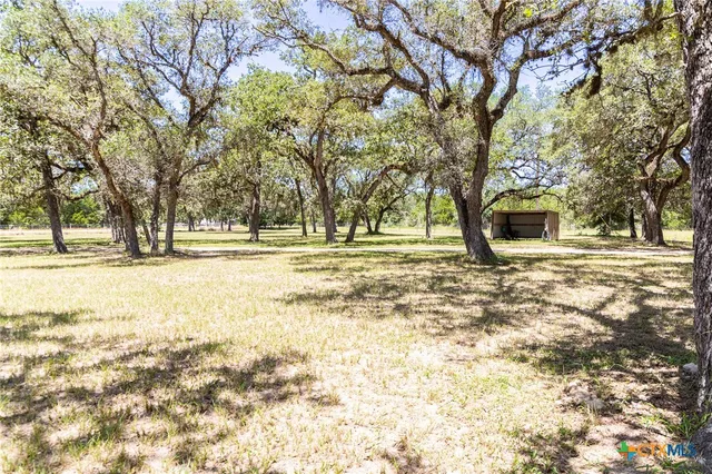 a view of swimming pool with a patio and wooden fence