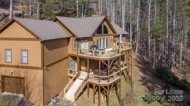 a aerial view of a house with roof deck front of house