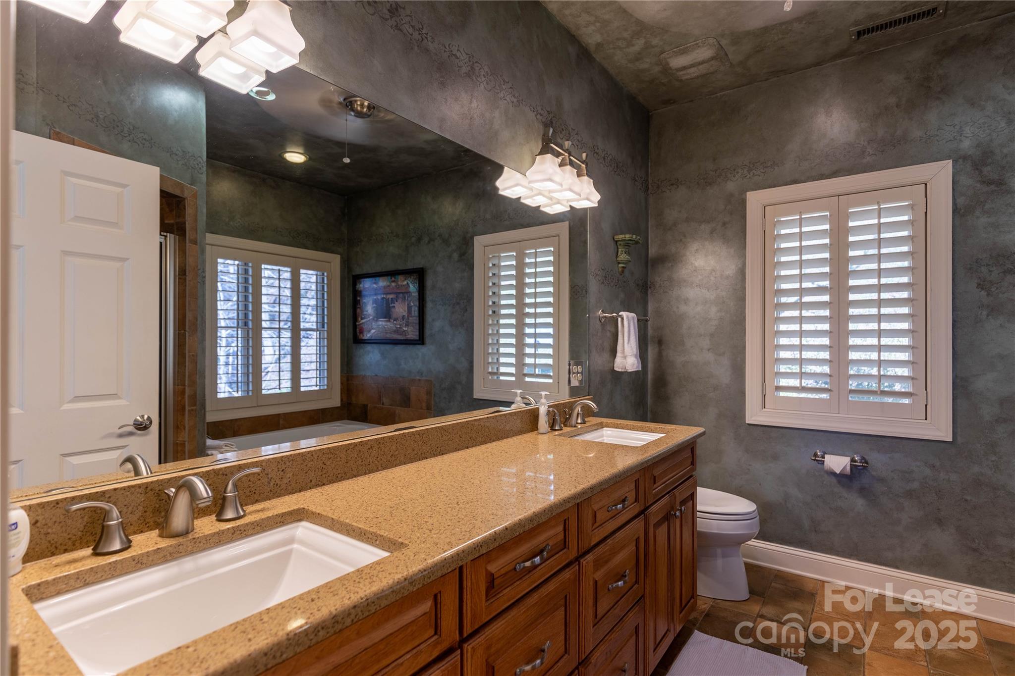 446 Windridge Drive Sugar Grove, NC 28679 - Photo 16 of 37 a bathroom with a sink double vanity and a mirror