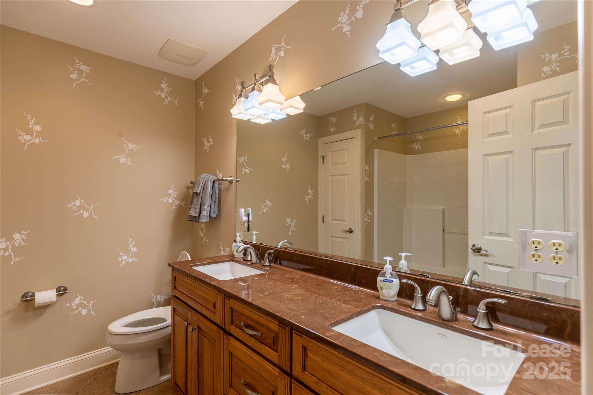 446 Windridge Drive Sugar Grove, NC 28679 - Photo 20 of 37 a bathroom with a double vanity sink and a mirror