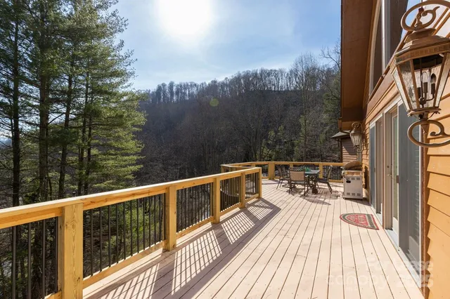 a view of a roof deck with table and chairs and wooden floor