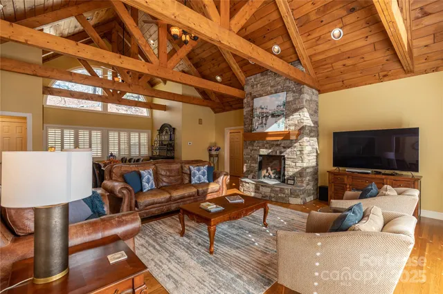 a large kitchen with stainless steel appliances granite countertop a stove top oven a sink a dining table and chairs