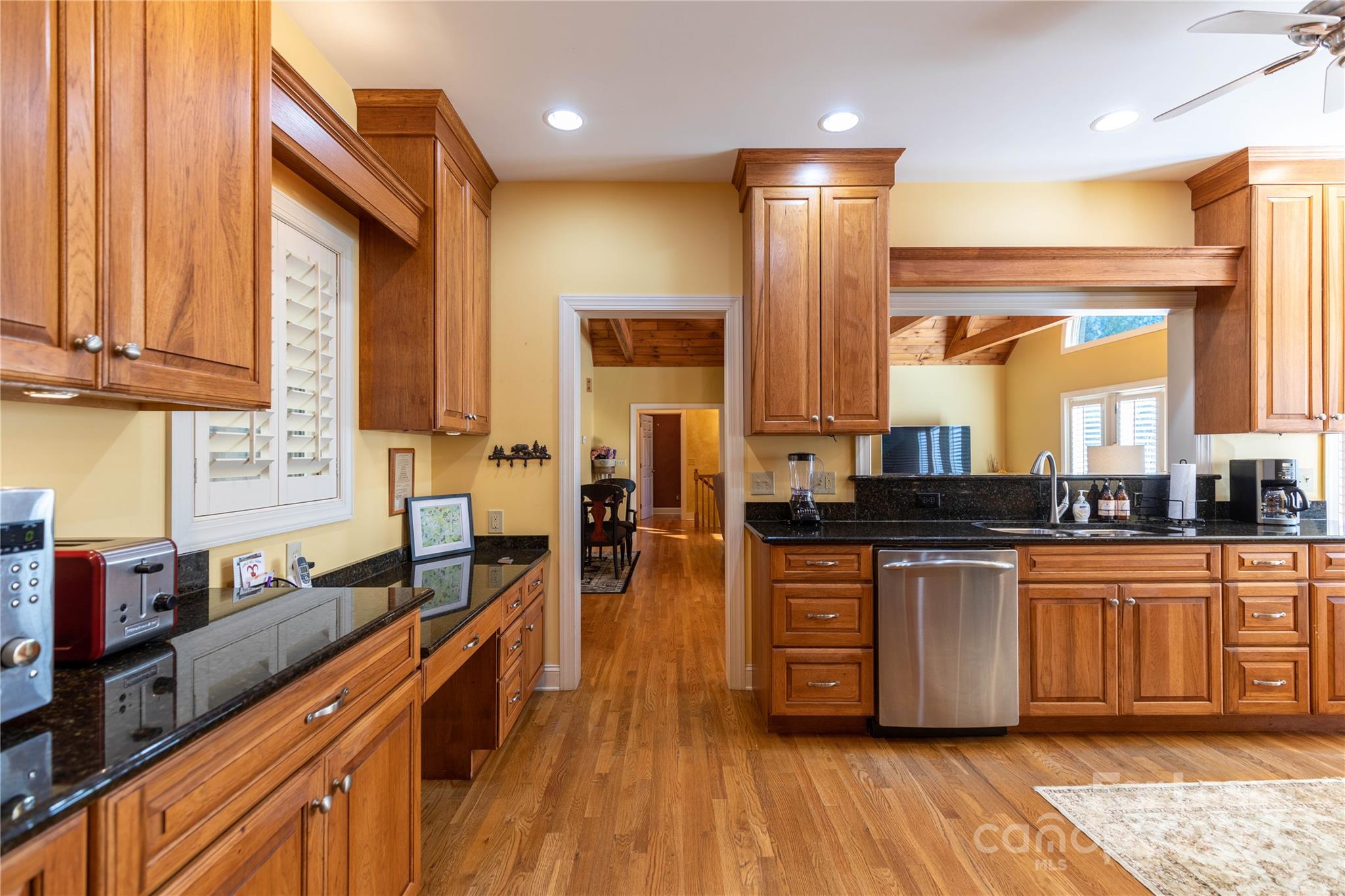 446 Windridge Drive Sugar Grove, NC 28679 - Photo 10 of 37 a kitchen with stainless steel appliances granite countertop a stove a sink dishwasher and cabinets with wooden floor