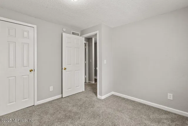 an empty room with closet area