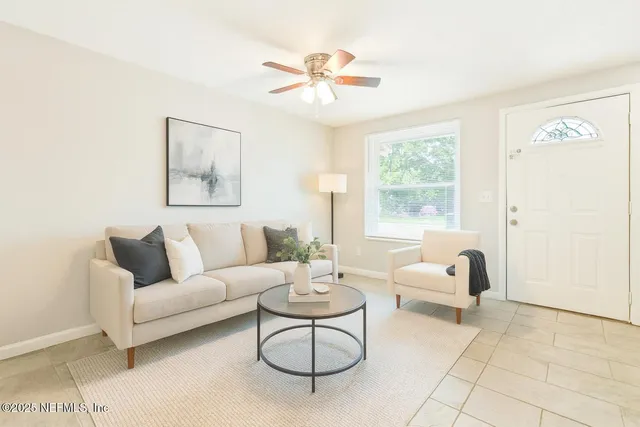 a living room with furniture and a large window