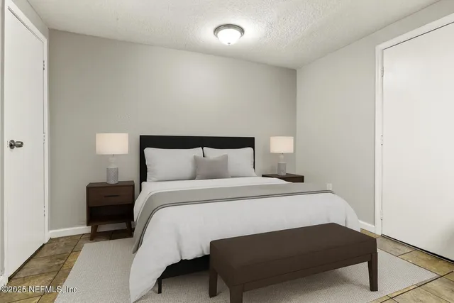 a bedroom with a bed and a night stand