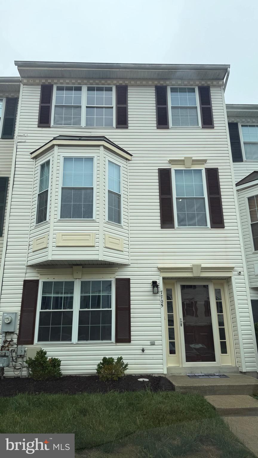 7705 Periwinkle Way, Unit 71 Severn, MD 21144 - Photo 1 of 28 a front view of a house with a yard