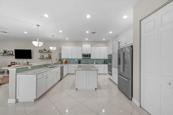a large kitchen with a large counter top appliances and cabinets