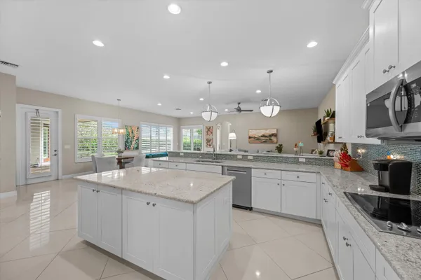 a kitchen with sink stove top oven and cabinets