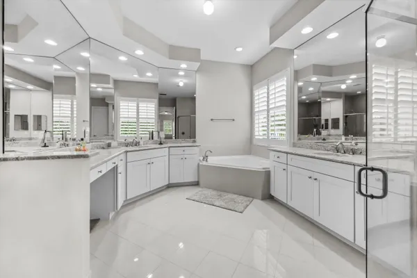 a large white kitchen with a large window