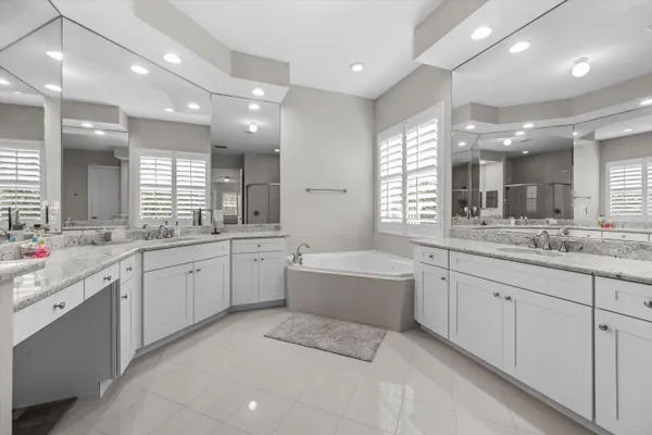 a large bathroom with a large tub and sink