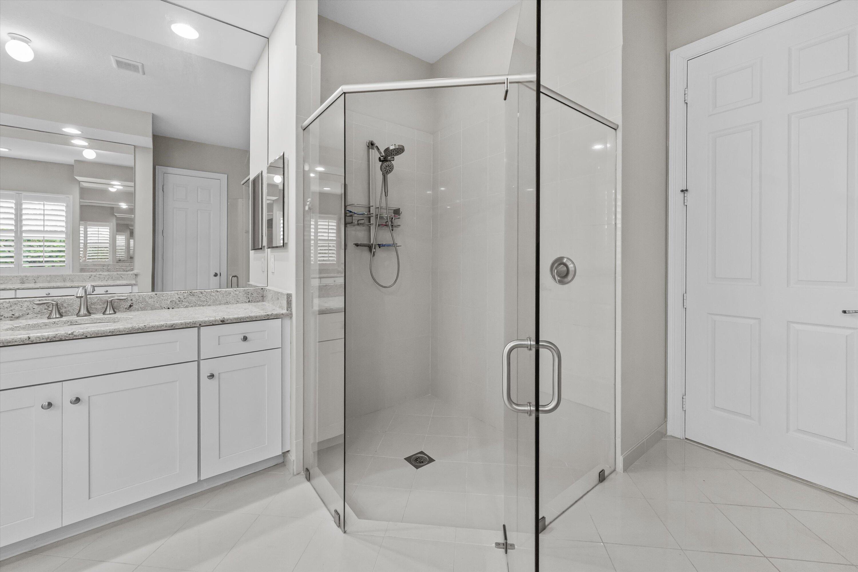 108 Casa Circle Jupiter, FL 33458 - Photo 22 of 53 a bathroom with a shower sink and mirror