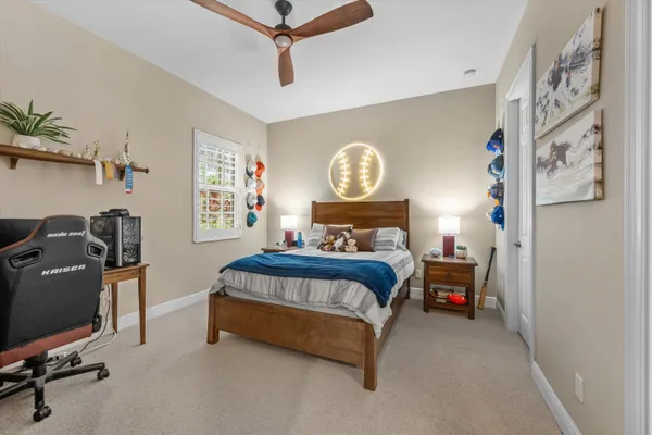 a bedroom with a bed workspace and a window