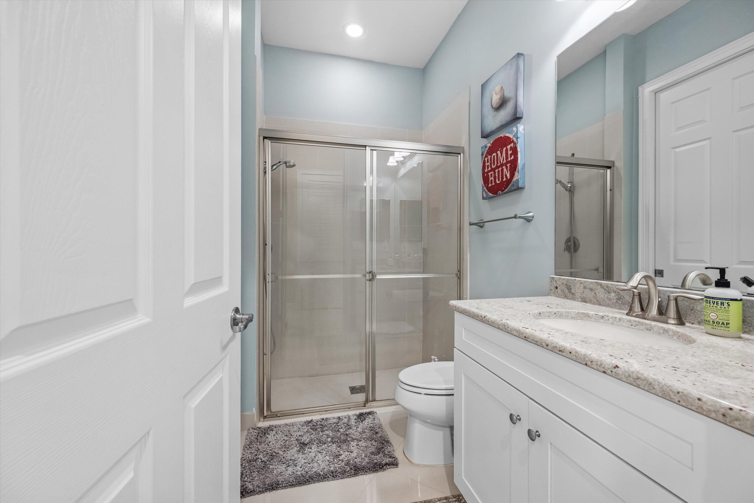 108 Casa Circle Jupiter, FL 33458 - Photo 25 of 53 a bathroom with a granite countertop sink toilet and shower