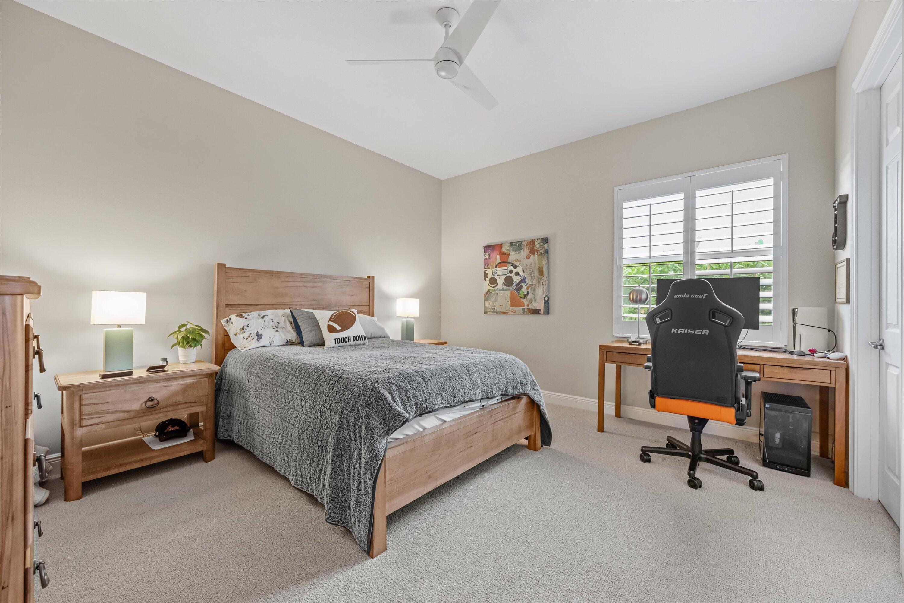 108 Casa Circle Jupiter, FL 33458 - Photo 26 of 53 a bedroom with a bed and a chandelier