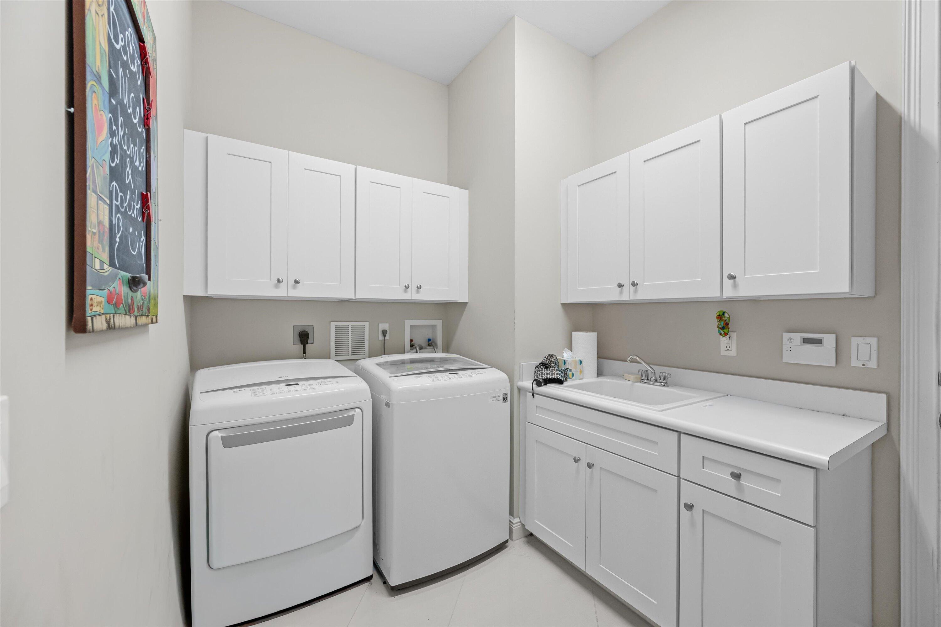 108 Casa Circle Jupiter, FL 33458 - Photo 32 of 53 a view of storage and utility room with washer and dryer