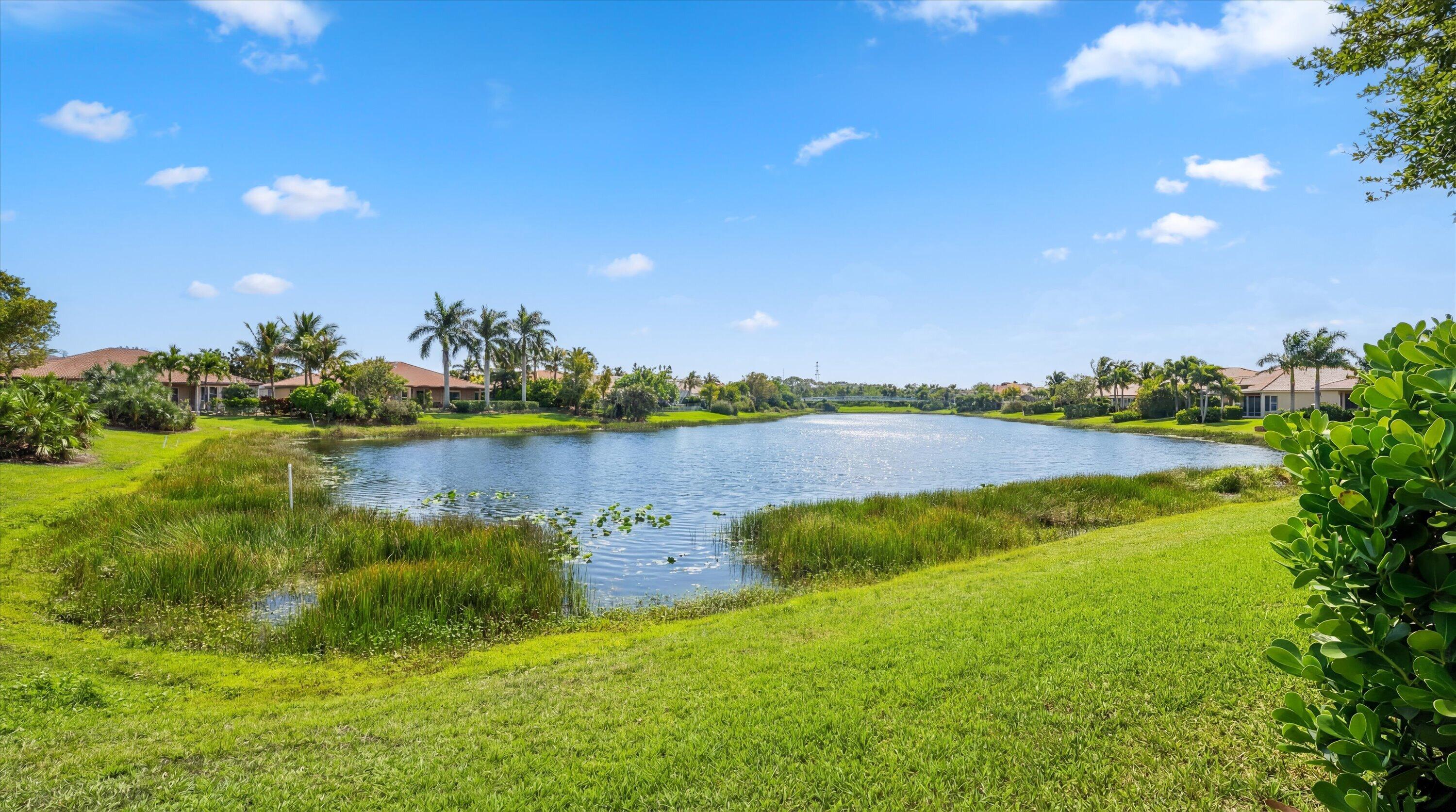 108 Casa Circle Jupiter, FL 33458 - Photo 35 of 53 a view of a lake with houses in the back