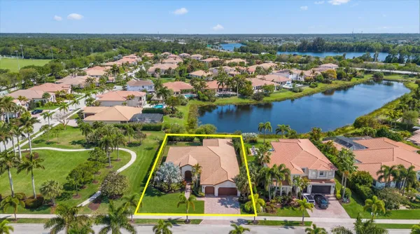 an aerial view of residential houses with outdoor space and river