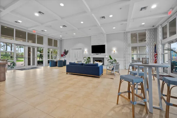 a view of a dinning room with furniture and flat screen tv