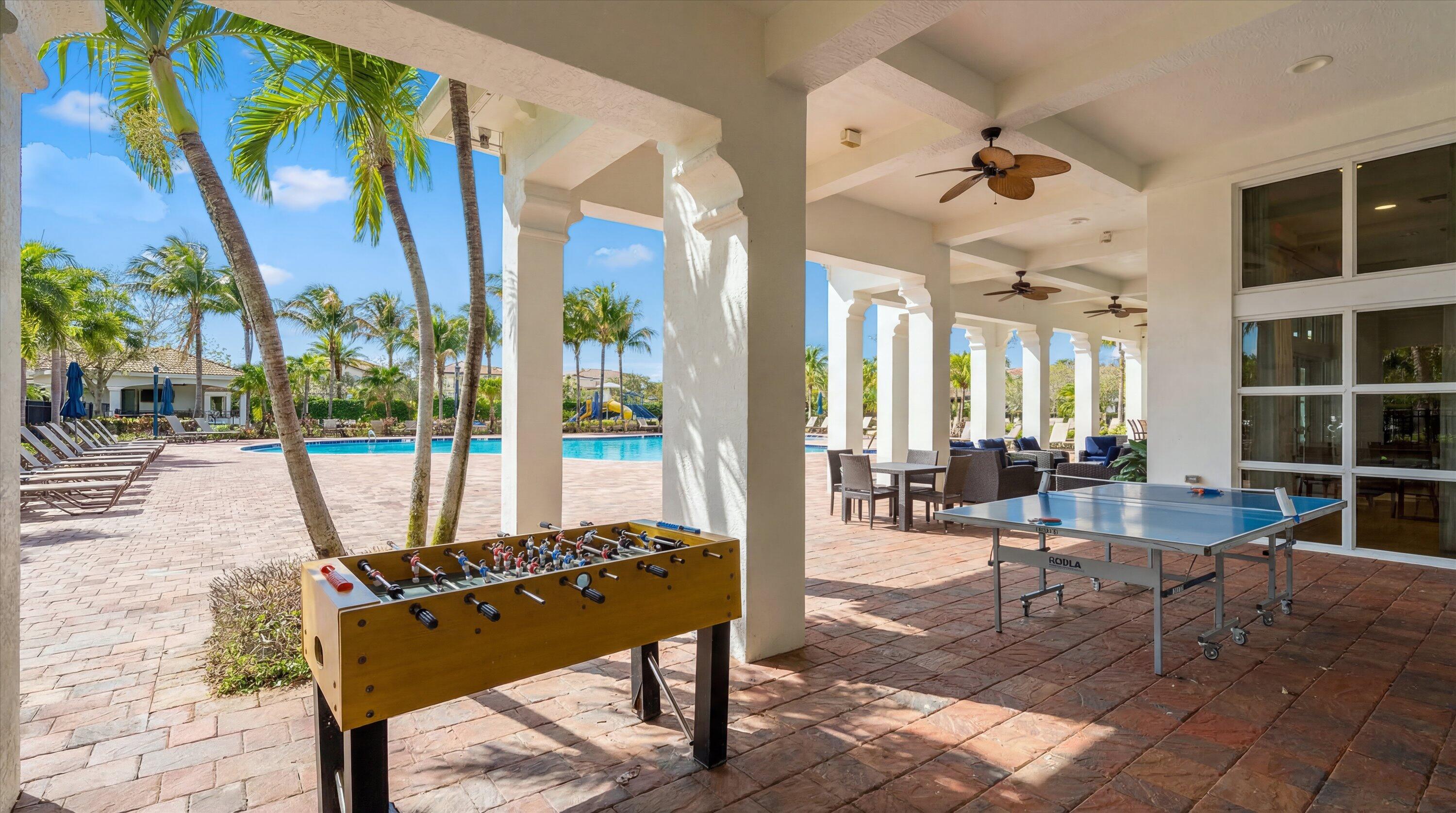 108 Casa Circle Jupiter, FL 33458 - Photo 44 of 53 a view of a patio with a dining table and chairs with wooden floor