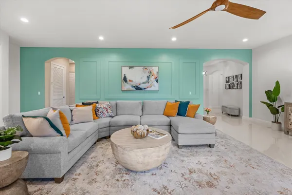 a living room with furniture and a potted plant