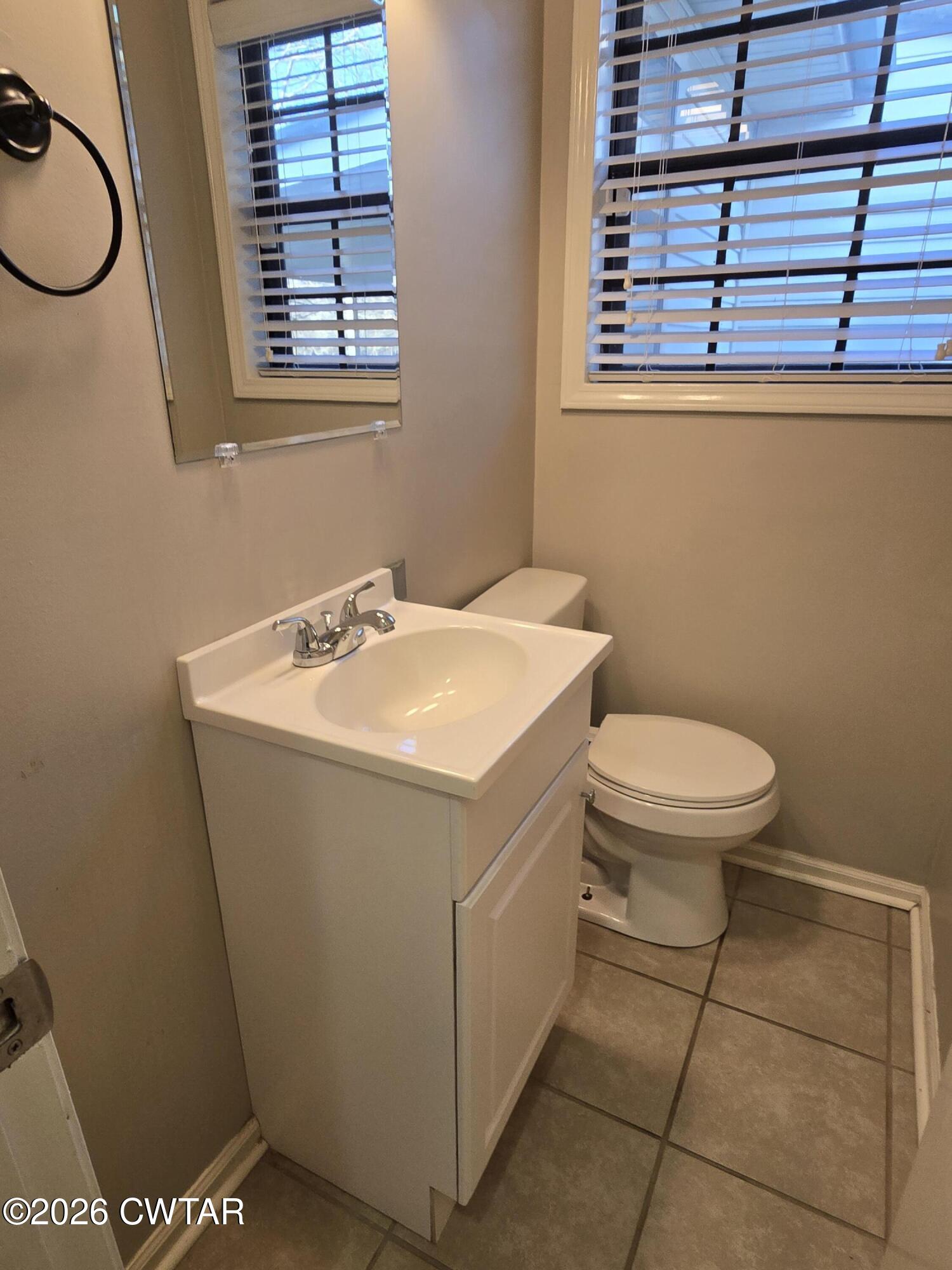 18 Lake Avenue Jackson, TN 38301 - Photo 11 of 19 a bathroom with a sink a toilet and a window